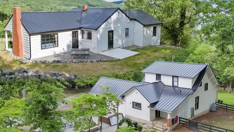 Front view of the farmhouse and guest cabin