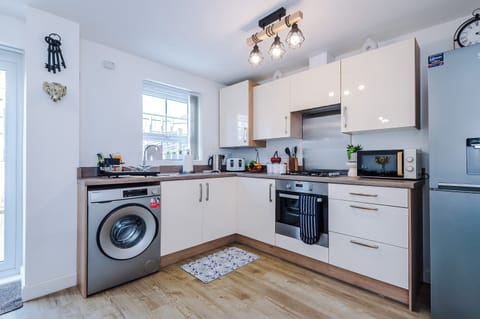 The bright and spacious kitchen has everything you could possibly need to cook during your stay. To name a few, there is a microwave, toaster, kettle, oven and washing machine plus a dining area that seats 4.