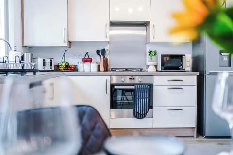 The bright and spacious kitchen has everything you could possibly need to cook during your stay. To name a few, there is a microwave, toaster, kettle, oven and washing machine plus a dining area that seats 4.