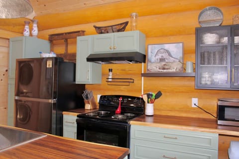 Kitchen with full refrigerator, stove, dishwasher and microwave 