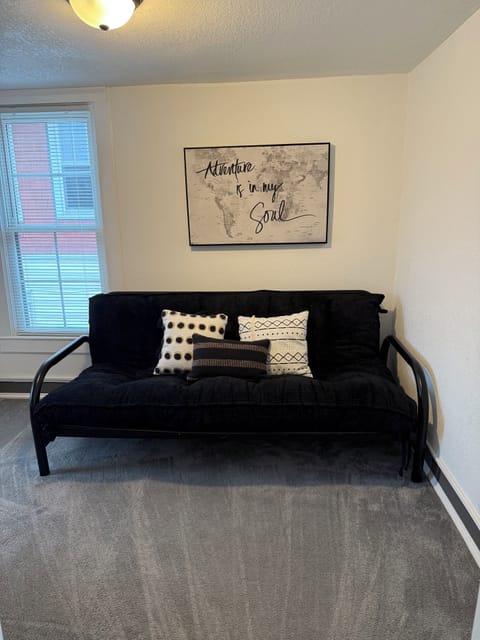 Queen size futon in office area next to bedroom.