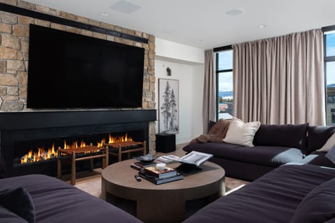Grand (Penthouse) - Sophisticated lounge with plush seating and a sleek gas fireplace
