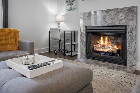 A dedicated desk corner paired with a fireplace makes working from home warm and inviting.
