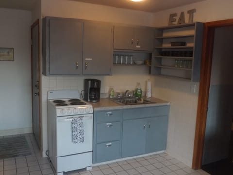 Full kitchen with refrigerator, stove, microwave, coffee makers, and most essentials