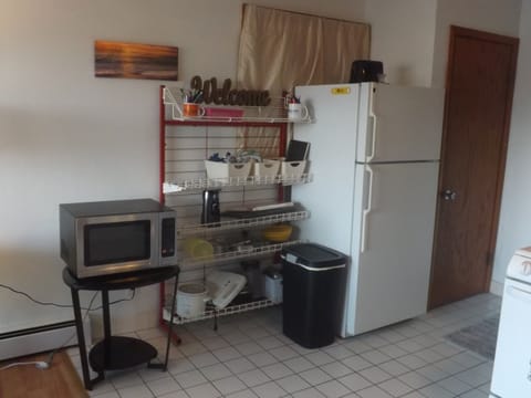 Full kitchen with refrigerator, stove, microwave, coffee makers, and most essentials