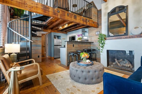 Spacious, charming living room with cozy furniture and fixtures.