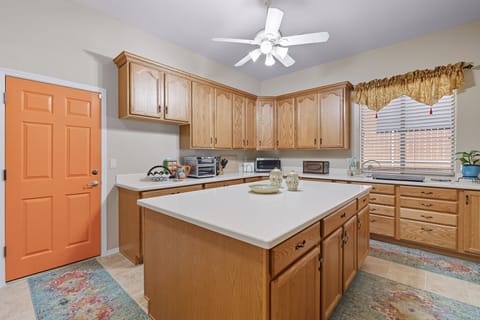 Orange door in Private Casita kitchen goes to garage