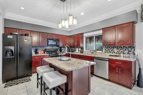 Fully-equipped kitchen with granite counters and center island.