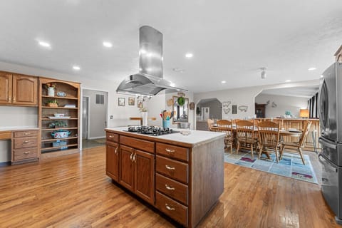 Kitchen | Expansive Space with Oak Cabinetry, Center Island & Stainless Steel Appliances