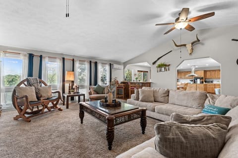 Living Room | Spacious Layout with Plush Sectional, Warm Natural Light & Classic Wood Accents