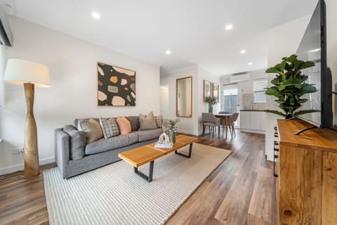 Settle into the soft tones and open layout of the living area, perfect for unwinding after a day exploring Adelaide.