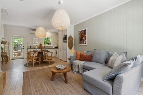 Open plan living and dinning invite you to come together and relax in a calming, coastal space.