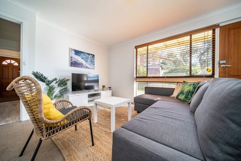 Stretch out on the chaise sofa in the relaxed living room, a comfortable spot to unwind after a day spent along nearby Grange Beach.