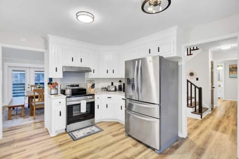 Bright, fully equipped kitchen with stainless appliances and ample space.