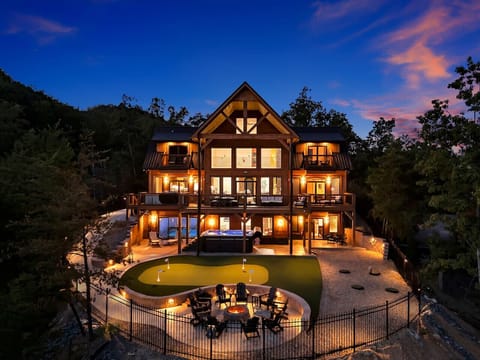 A breathtaking twilight view of the cabin and its private outdoor spaces, perfect for entertaining or simply enjoying the mountain air.