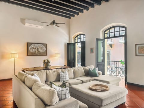 Expansive Spanish Colonial living room with three balconies & soaring ceilings.