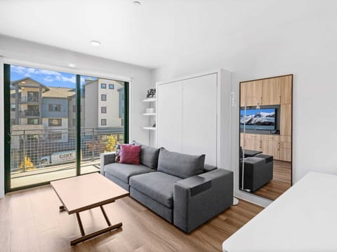 Studio living area with queen Murphy bed and balcony