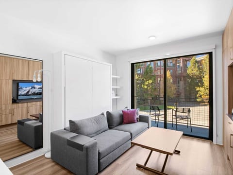 Studio living area with queen Murphy bed and balcony