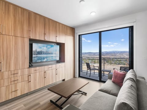 Studio living area with queen Murphy bed and balcony