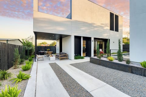 Modern home with a sleek, minimalist exterior, featuring a private backyard with a plunge pool.