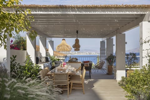 Catrine's gorgeous, shady al fresco dining area and kitchen with its views out to sea.