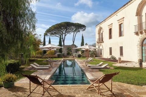 The splendid pool area and gardens at Casino Doxi Stracca with the palazzo on the right.