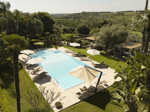 The vivid greens of the manicured gardens and the surrounding countryside.