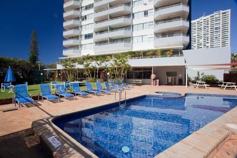 Outdoor pool area with sun loungers, BBQ space, heated pool and spa access here.