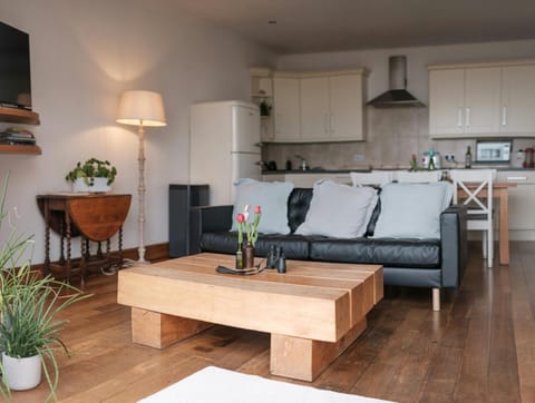 Living area with sofa, coffee table, standard lamp and occasional table