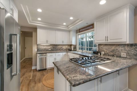 Gather around the kitchen island and enjoy casual dining in this bright and airy space