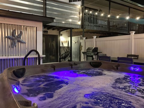 Back patio with grill, dining, swing chair, and new hot tub