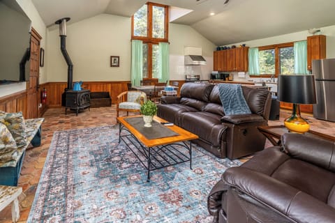 Spacious living area with cathedral ceilings and natural light.
