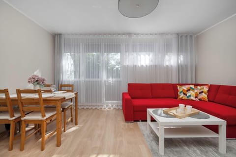 The stylish bedroom includes a comfortable sofa bed and a wardrobe.