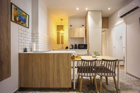 Warm lighting and modern wood finishes create a welcoming kitchen and dining area perfect for shared meals.