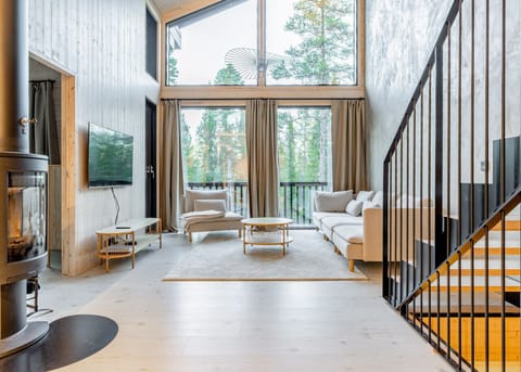 Modern Scandinavian design meets cozy comfort. Relax by the fireplace while enjoying floor-to-ceiling forest views.