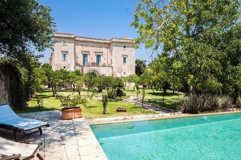 The handsome facade of Palazzo Colucci seen from the pool.