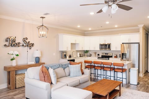 🛋️ Relax in the comfy living room with a sofa and ottoman, or gather at the kitchen island with seating for four. A fully equipped kitchen with stainless appliances makes cooking and entertaining effortless.