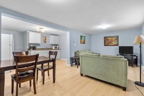 Bright and airy open-concept living area featuring comfortable seating and a view of the dining and kitchen space. Perfect for socializing and relaxing.