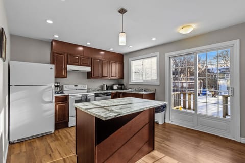 Cover Photo: Fully equipped kitchen featuring granite countertops, a center island for prep, and modern appliances. Perfect for home-cooked meals.