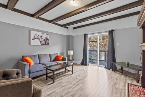 Living Room: Relax in the bright living area with plush seating, a flat-screen TV, and sliding doors leading to your private deck.