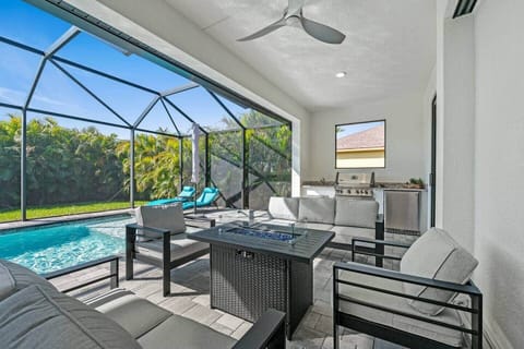 Escape to this luxury screened-in patio & pool oasis!  Lounge by the sparkling pool, unwind by the fire pit, or enjoy the outdoor kitchen. Private, peaceful, and perfect for relaxation. Your dream getaway starts here—book now! ☀️‍♂️