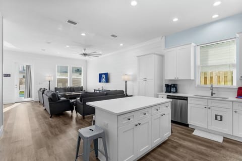 Spacious open-plan living area with modern kitchen and comfortable seating.