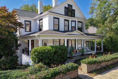 Slow down and savor the moment on the wide front porch — rocking chairs, pretty flowers, and all.