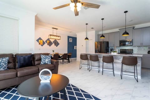  Enjoy the smart TV, ceiling fan, and open floor concept, creating a bright and inviting atmosphere.