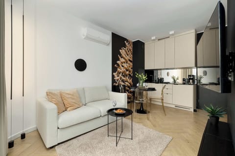 Relax in the stylish living area with a comfortable sofa and modern decor.