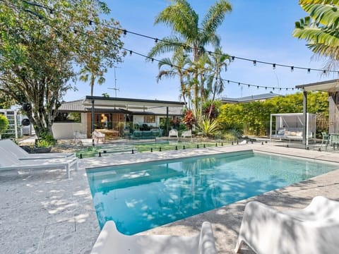 Backyard with private pool, alfresco dining, built-in BBQ, and canal views.