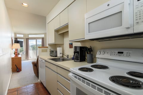 Bright galley kitchen with updated appliances and essentials