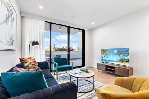 Stylish comfort – Modern sofa, accent chairs, and vibrant cushions create a welcoming space to relax.