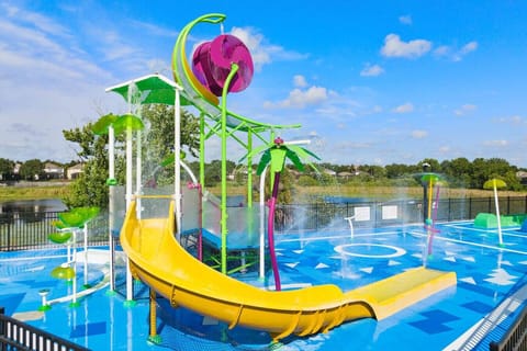 Colorful splash pad with slides and water features for family fun by the lake