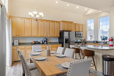 Fully stocked kitchen with modern appliances and breakfast bar seating